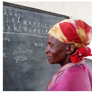 A woman standing in front of a blackboard at a literacy course