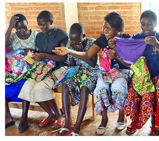 Women receiving a kit on the feminine hygeine project